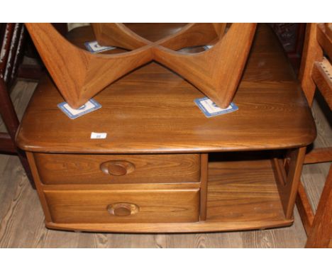 An Ercol dark elm 'Pandora' coffee table, model number 735.There are some light coloured water marks to the top. Drawers open