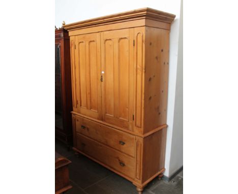 A 19th century pine linen press, arched panelled doors, two drawer base with Gothic style handles, width 161cm, depth 61cm & 