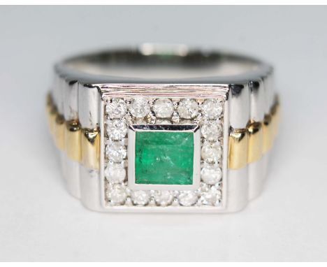 A gent's emerald and diamond Rolex design signet ring, the central square cut bezel set emerald weighing approx. 0.66 carats,