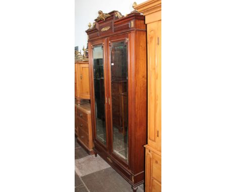 A continental gilt mounted walnut armoire with mirrored doors, width 126cm, depth 48cm & height 233cm.  Condition:- General w