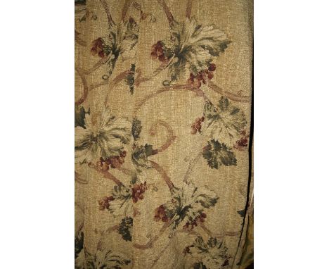 A PAIR OF CURTAINS with floral designs on a beige ground, lined, and a pelmet
