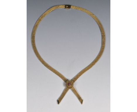 AN 18CT GOLD NECKLACE of stylised ribbon form, the central pendant with ruby setting