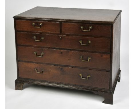 A GEORGE III COUNTRY OAK CHEST OF DRAWERS with two short and three long drawers, each with original square handles, on bracke
