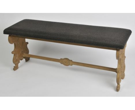 A COUNTRY HOUSE STYLE PAINTED WOOD BENCH with upholstered rectangular seat, the ends carved in an Italianate style, 140cm wid