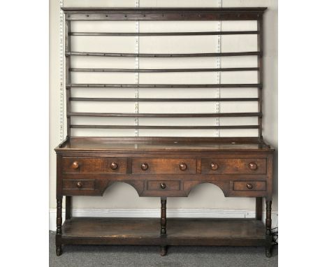 A 19TH CENTURY OAK DRESSER, the top having three shelf rack, the base having a moulded edged rectangular top above four short