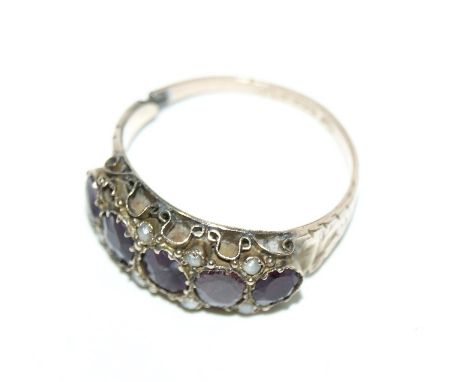 A VICTORIAN 9CT GOLD RING with stylised amethyst and pearl setting.
