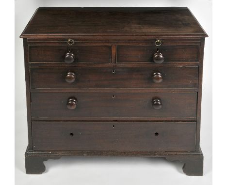 A GEORGE III MAHOGANY CHEST with a slide out section above two short and three long drawers, each with turned knob handles, o