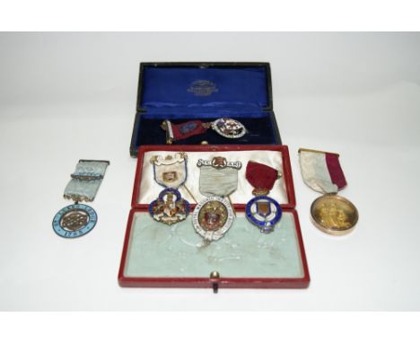 A COLLECTION OF SIX MASONIC MEDALS and badges with enamel decoration including one in 14ct gold frame