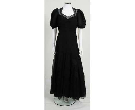 A 1920S/1930S LONG BLACK CREPE DRESS, embroidered floral detailing to sleeves and skirt, sheer upper back, net detailing to n