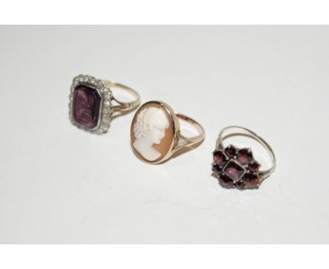 A 9CT GOLD SEAL RING with amethyst setting, a 9ct gold cameo ring and a further ring with garnet settings