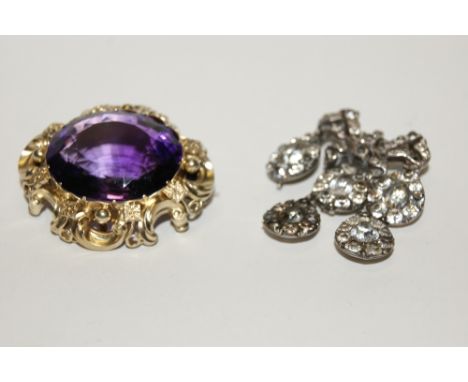 AN AMETHYST BROOCH in stylised frame,  together with a paste pendant of stylised drop form