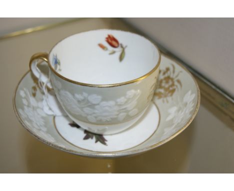 A SPODE TEA CUP and saucer painted with flowers within a relief moulded border, pattern number 2109 and an early 19th Century