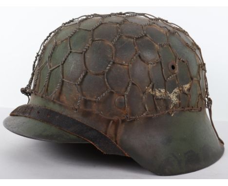 Luftwaffe Field Division Camouflaged Steel Combat Helmet, being a M-42 pattern steel helmet with areas of light green camoufl