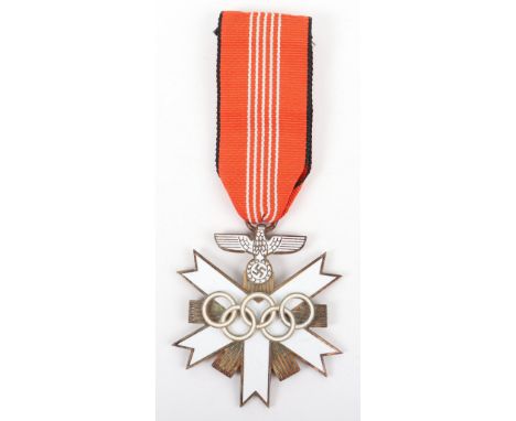 Third Reich Olympic Games Decoration, gilt and enamel example complete with its ribbon. Two piece construction.   This auctio