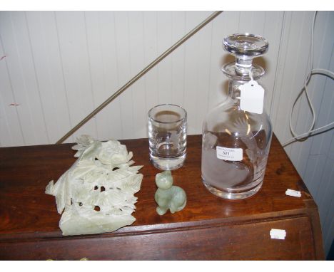 A Stuart Glass decanter with bird and mountain etched design, similar glass, a jade cat and carved jade scene 