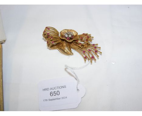 An 18ct yellow gold ruby and diamond brooch, taking the form of a Boutonniere 
