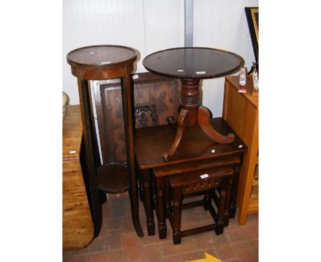 A nest of three dark oak occasional tables, together with a circular occasional table, a two tier plantstand and a fire scree