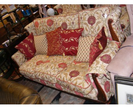 A three seater sofa upholstered in red, green and gilt floral patterned fabric - width approx. 184cm 