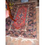 A Middle Eastern rug with geometric border and cen