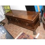 A Continental antique coffer standing on lion paw