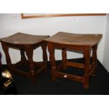 A pair of unusual Mouseman curve top wooden stools