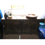 A period oak carved panelled coffer with intricate