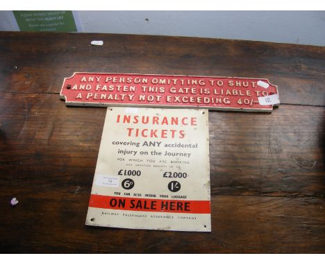 An old enamel insurance ticket sign together with and old railway gate sign