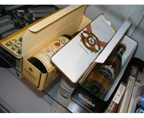 A bottle of Glenfiddich and another of Glenlivet Scotch Whisky in presentation tins 