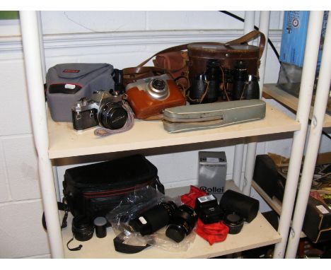 Vintage optical equipment, including binoculars and cameras - on two shelves 