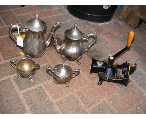 A four piece silver plated tea set, together with vintage kitchen mincer