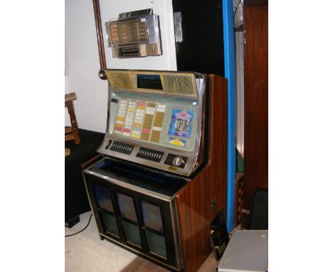 A vintage Rock-Ola juke box with wall mounted remote (for restoration)