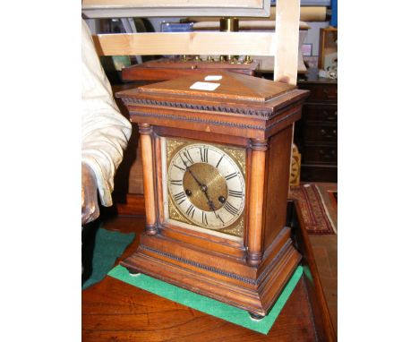 A walnut cased striking mantel clock with silvered dial 