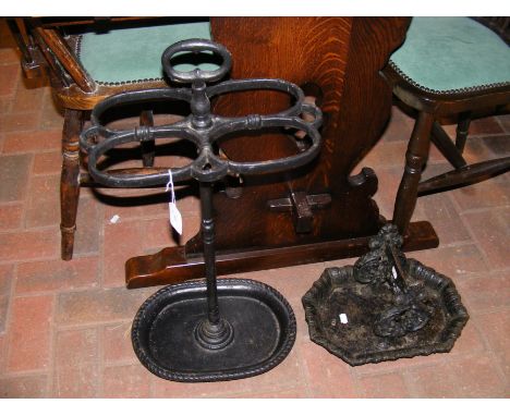 An antique Victorian cast iron boot scraper and similar stick and umbrella stand 