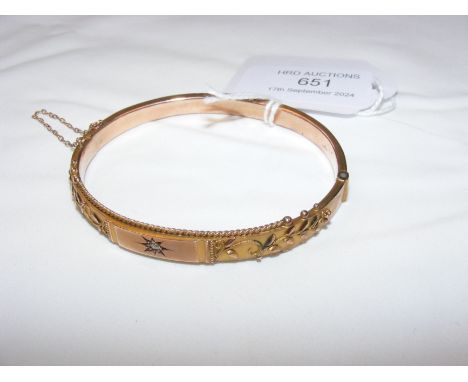 A 9ct yellow gold bangle with single diamond 