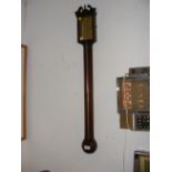 A modern wall barometer/thermometer