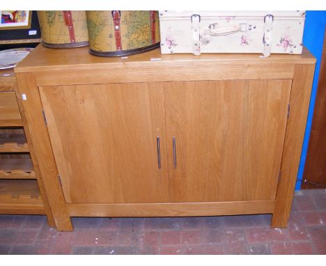 A contemporary light oak sideboard with two door cupboard (matching Lot 310) - width 112cm 