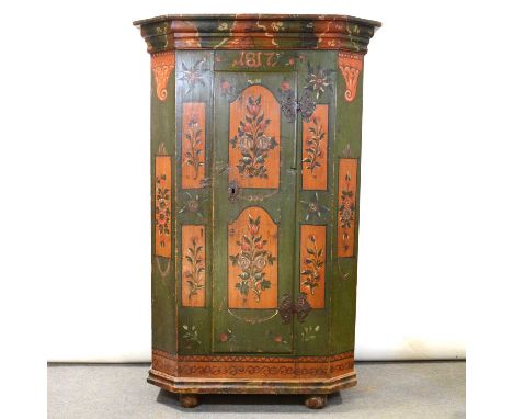 European painted pine cupboard, moulded cornice above a door with elaborate metal hinges, bun feet, painted with flowers and 