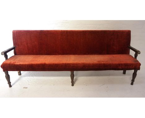 LARGE OAK FRAME BENCHearly 20th century, with a padded back and seat, covered in a terracotta velvet, standing on three turne