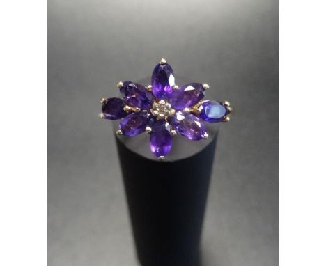 AMETHYST AND DIAMOND CLUSTER RINGthe oval cut amethyst cluster around a small central diamond, on nine carat gold shank, ring