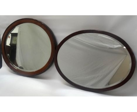 OVAL MAHOGANY WALL MIRRORwith a bevelled plate, 52.5cm wide; a shaped teak wall mirror with pierced door decoration, 45.5cm h