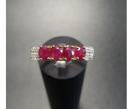 RUBY AND DIAMOND RINGthe four oval cut rubies flanked by four small diamonds to each shoulder, on nine carat gold shank, ring