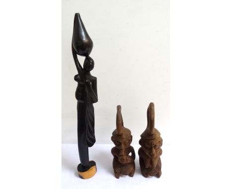 PAIR OF CARVED AFRICAN FERTILITY FIGURESsmoking a pipe, and a woman kneeling and having an integral handle, 26.5cm and 29cm h