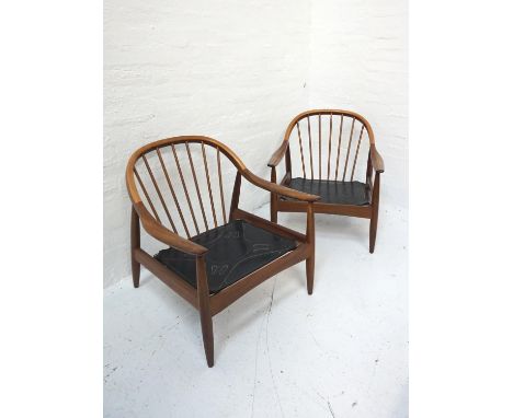 PAIR OF 1960s 'GREAVES & THOMAS' TEAK ARMCHAIRSwith arched stick backs above shaped arms, with loose shaped button back cushi