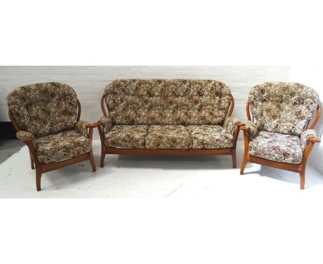 BEECH EFFECT STICK BACK SUITEcomprising one three seat settee and two single seat chairs with floral pattern upholstery (3) 