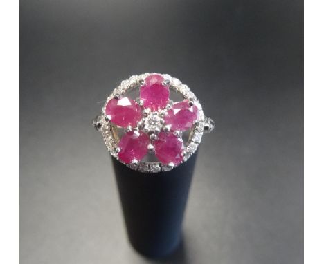 RUBY AND DIAMOND CLUSTER RINGthe five oval cut rubies and central diamond forming a flower head, within a further circle of d