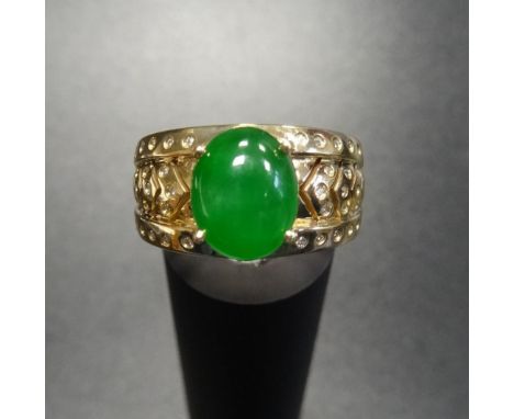 UNUSUAL JADE AND DIAMOND DRESS RINGthe central oval jade cabochon flanked by diamond set chevron effect shoulders, in eightee