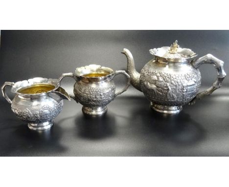 INDIAN SILVER TEA SERVICEcomprising teapot, sugar basin and milk jug, the teapot with 'Ganesh' finial to the hinged cover, th
