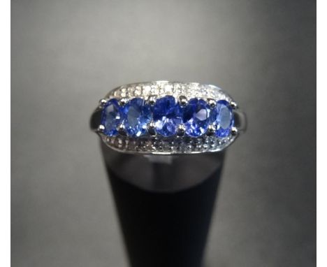 TANZANITE AND DIAMOND DRESS RINGthe five oval cut tanzanites with small diamonds above and below, on nine carat white gold sh