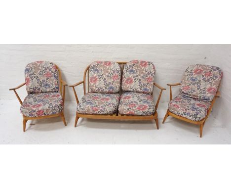 ERCOL THREE PIECE SUITEComprising one two seat sofa and two single seat armchairs with floral fabric coverings 