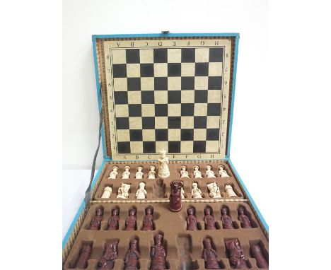 EXPORT WARE CHINESE CHESS SETwith resin brown and white pieces contained in a decorated and fitted case, with a playing board